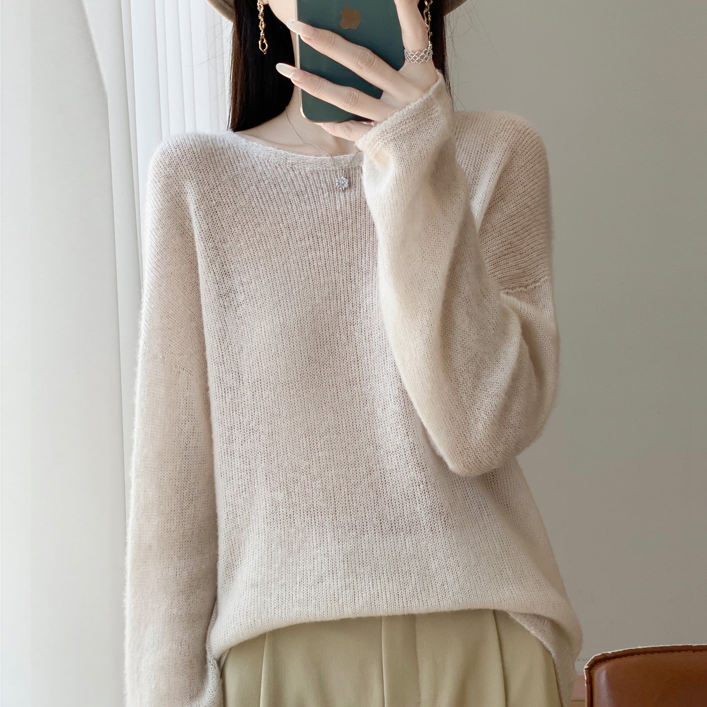 Round neck sweater top paired with knitted sweater for women
